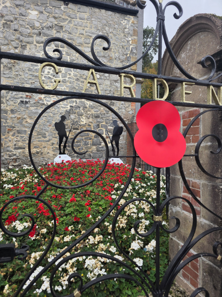 Silent soldiers in a field of flowers at Langmoor Gardens gates